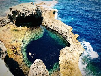 High angle view of rock formation in sea