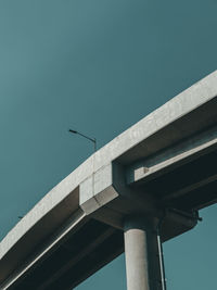 Low angle view of bridge against clear blue sky during sunny day