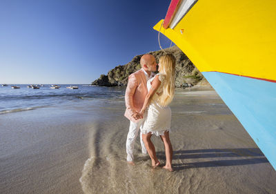 Full length of woman on beach against sky