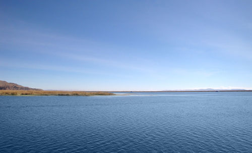 Scenic view of sea against blue sky