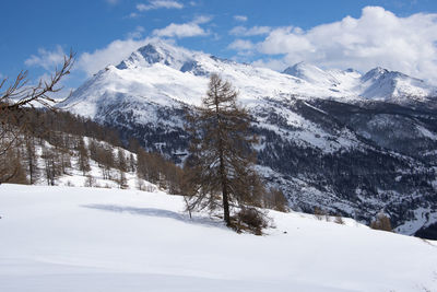 Scenic view of snow covered mountains against sky