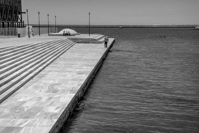 Quayside by sea against sky