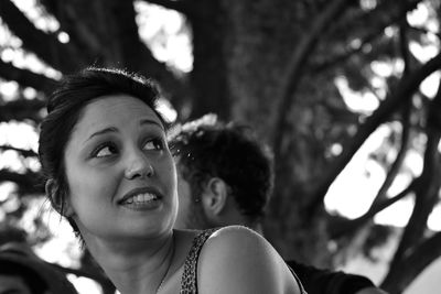 Close-up of happy girl against trees