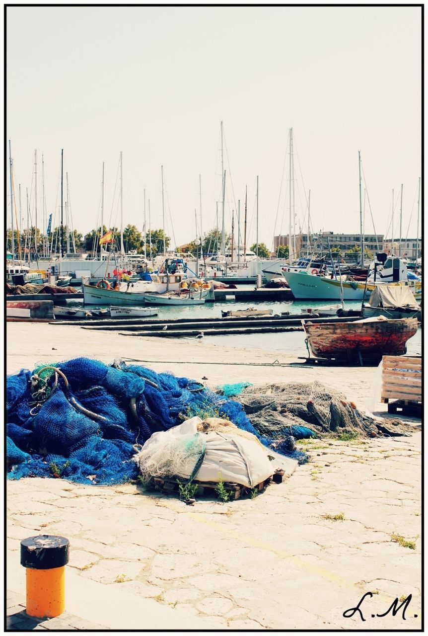 nautical vessel, transportation, moored, mode of transport, boat, water, harbor, transfer print, mast, sea, auto post production filter, sky, in a row, travel, sailboat, clear sky, outdoors, beach, day, nature