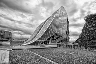 Low angle view of bridge against cloudy sky