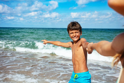 Portrait of shirtless boy at beach