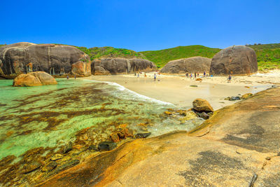 Scenic view of beach against clear blue sky