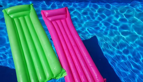 High angle view of multi colored floating on swimming pool