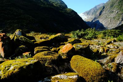 Scenic view of rocks and mountains against sky