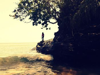 Man surfing in sea against sky