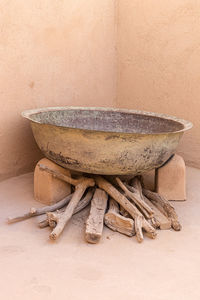 Close-up of old table against wall