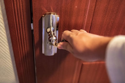 Close-up of hand holding door knob