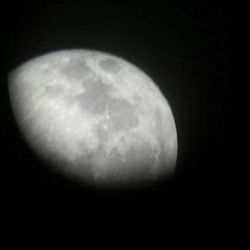 Low angle view of moon over black background