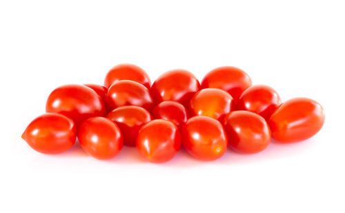 Close-up of tomatoes over white background
