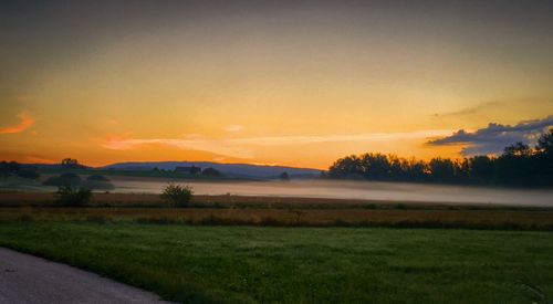 Scenic view of field against sky during sunset