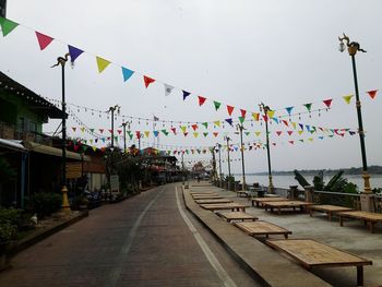 Multi colored flags hanging against sky