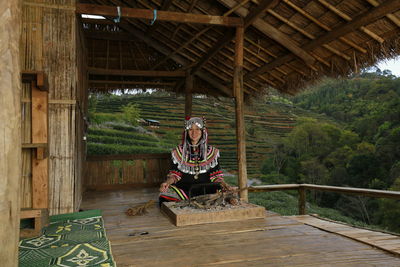 Portrait of farmer in traditional clothes preparing bonfire