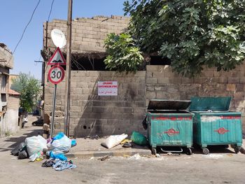 Garbage bin against building in city