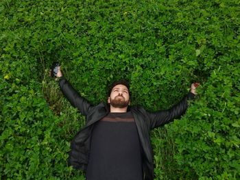 Full length of a man standing on green plants