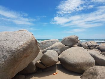 Rocks by sea against sky