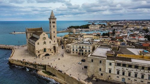 High angle view of buildings by sea against sky