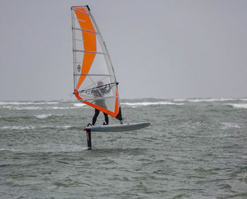 Sailboat on sea against sky