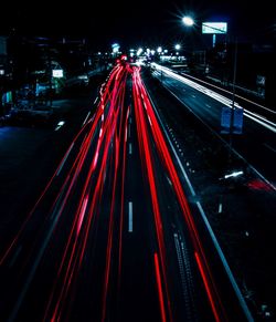 High angle view of light trails on road at night