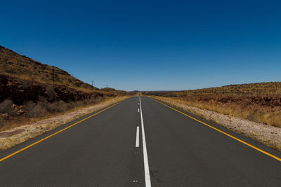 Empty road along countryside landscape