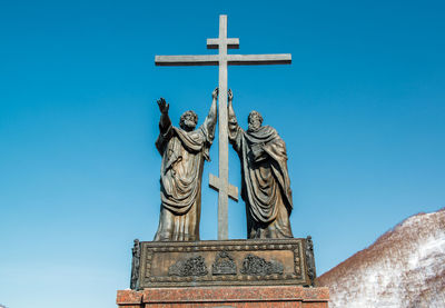 Low angle view of statue against blue sky