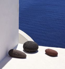 High angle view of pebbles by sea in thera, santorini, greece. 
