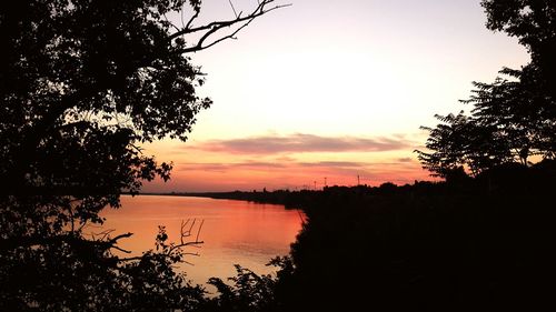 Scenic view of lake against sky during sunset