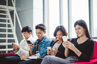 Friends sitting on mobile phone