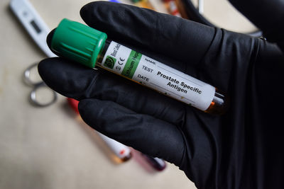 Midsection of woman holding bottle