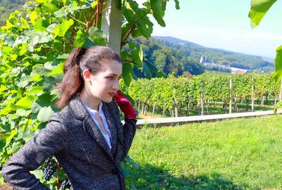 Beautiful woman standing at vineyard