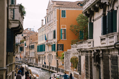 People on street amidst buildings in city