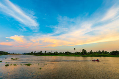 Scenic view of lake against sky during sunset