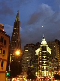 Low angle view of illuminated buildings against sky at night