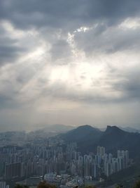 Aerial view of buildings in city against sky