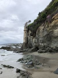 Rock formations by sea against sky