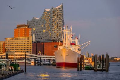 Ship in sea against buildings in city
