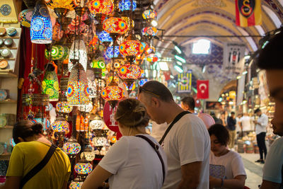 Rear view of people at market stall