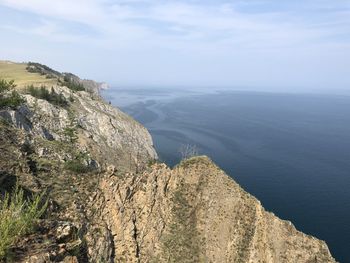 Scenic view of sea and mountains against sky
