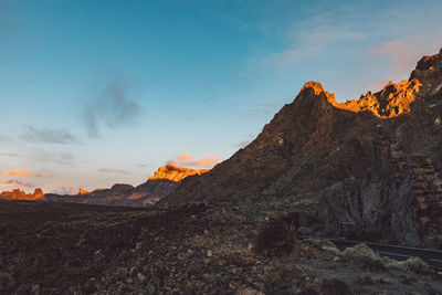 Scenic view of rocky mountains against sky during sunset