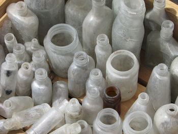 High angle view of empty old bottles in container