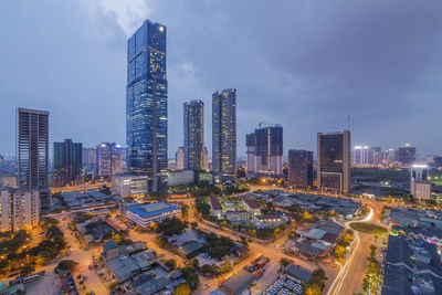 Aerial view of modern buildings in city against sky