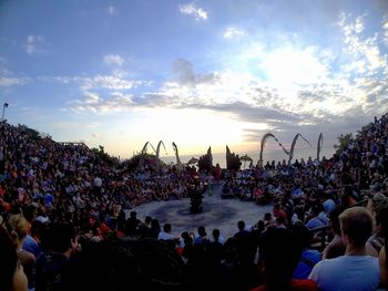 Group of people at music concert against sky