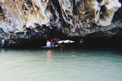 People on rock in water