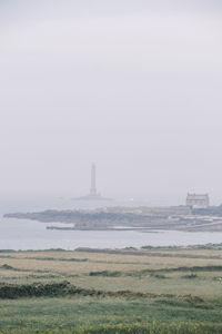 View of fog on landscape against sky