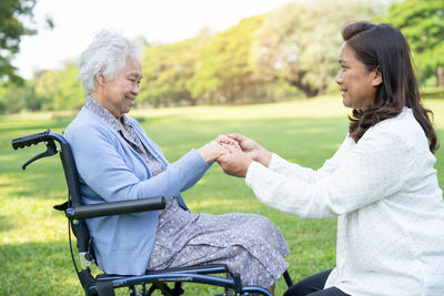 Holding hands asian senior woman patient with love, care, encourage  