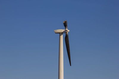 Wind turbine with a broken blade from being struck by lightning.